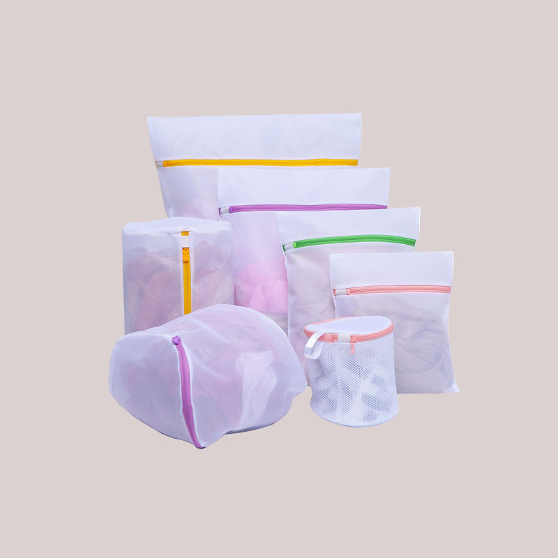 Set of mesh laundry bags with colorful zippers on a white background